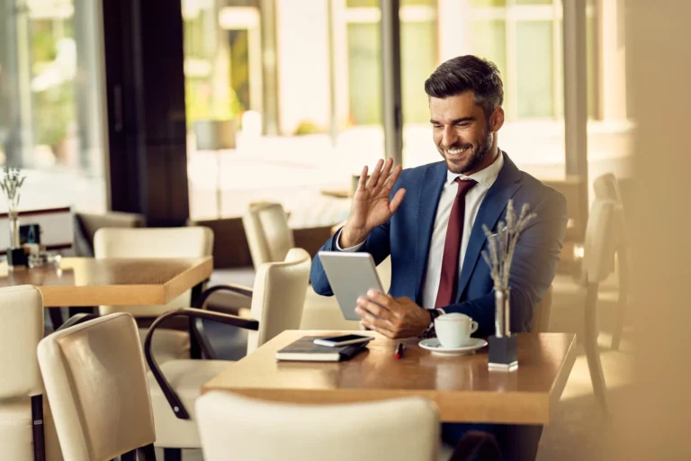 happy-businessman-making-video-call-touchpad-cafe_